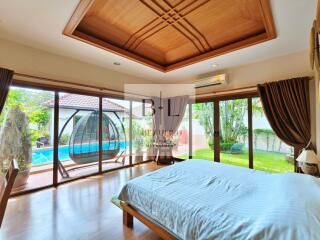 Spacious bedroom with pool view and ample natural light