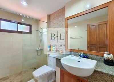 Modern bathroom with glass shower and large vanity mirror