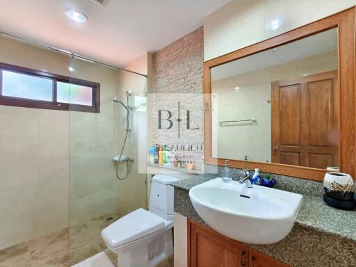 Modern bathroom with glass shower and large vanity mirror