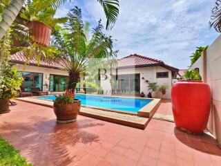 Beautiful backyard with a pool and lush greenery