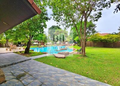 Spacious backyard with swimming pool and green lawn