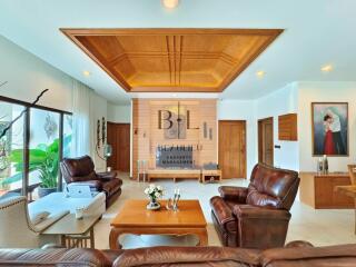 Spacious living room with wooden ceiling and leather furniture