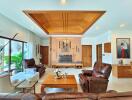 Spacious living room with wooden ceiling and leather furniture