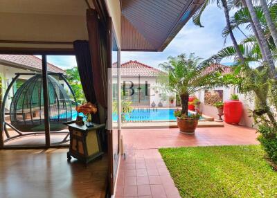 Outdoor patio with garden and pool view