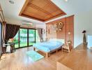 Spacious bedroom with wooden flooring, large windows, and modern decor