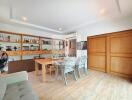 Spacious main living area with wooden shelves, table, and chairs