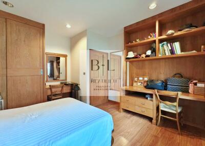 Modern and spacious bedroom with wooden storage units