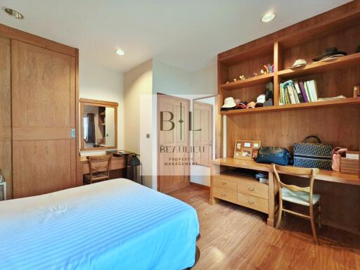 Modern and spacious bedroom with wooden storage units