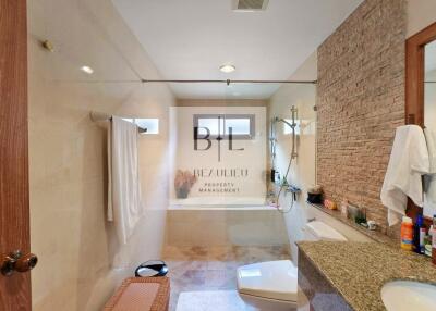 Modern bathroom with glass shower and granite countertop