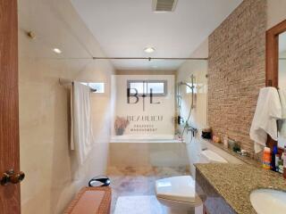 Modern bathroom with glass shower and granite countertop