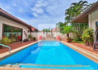 Outdoor swimming pool with deck and plants