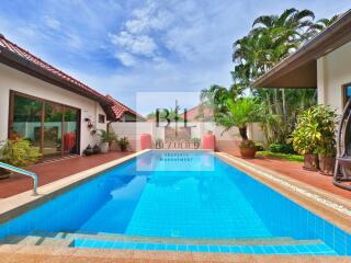 Outdoor swimming pool with deck and plants