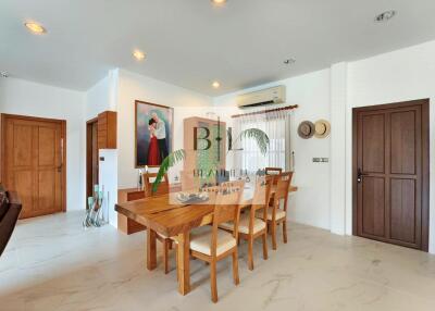 Modern dining area with wooden furniture and wall art