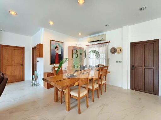 Modern dining area with wooden furniture and wall art