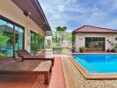 Outdoor pool area with lounge chairs and a view of the garden