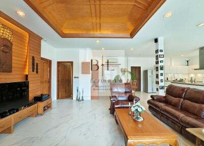 spacious living room with wooden ceiling and modern amenities