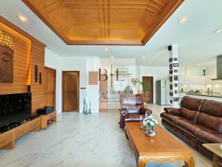 spacious living room with wooden ceiling and modern amenities