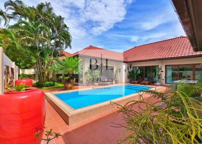 Spacious patio with swimming pool in a tropical garden