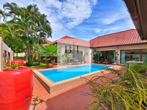 Spacious patio with swimming pool in a tropical garden