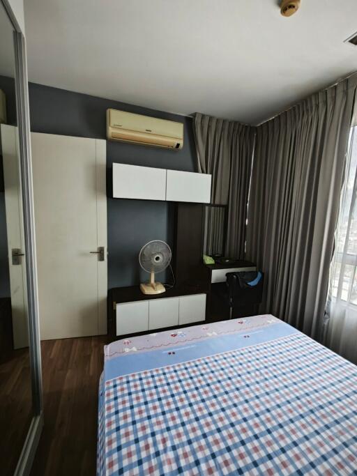 Bedroom with bed, air conditioning, wardrobe, and window with curtains