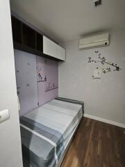 Small bedroom with wall art and air conditioner