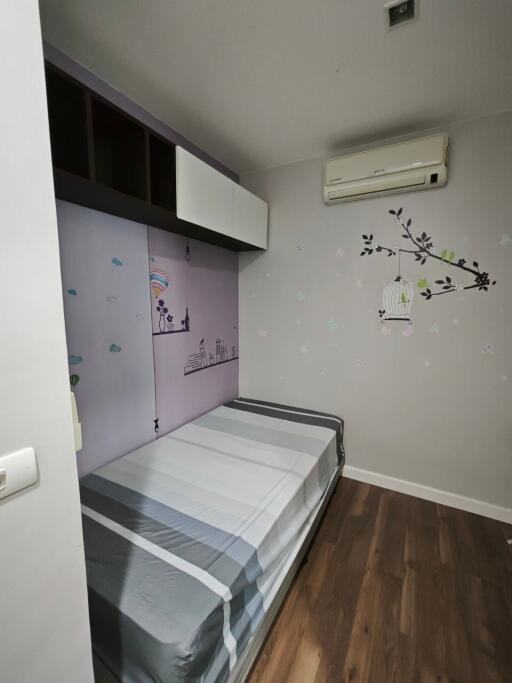 Small bedroom with wall art and air conditioner