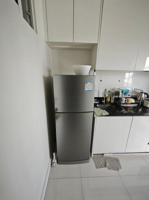 Modern kitchen with refrigerator and white cabinetry