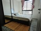 Modern bedroom with large window and striped bedding