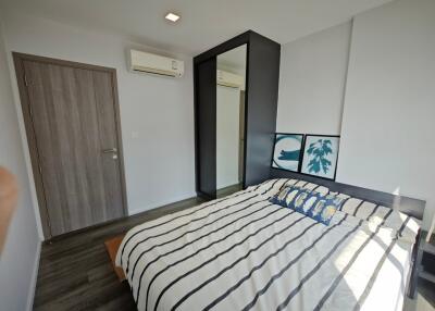 Bedroom with bed, closet, and air conditioner