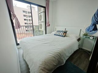 Cozy bedroom with double bed and balcony access