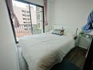 Cozy bedroom with double bed and balcony access