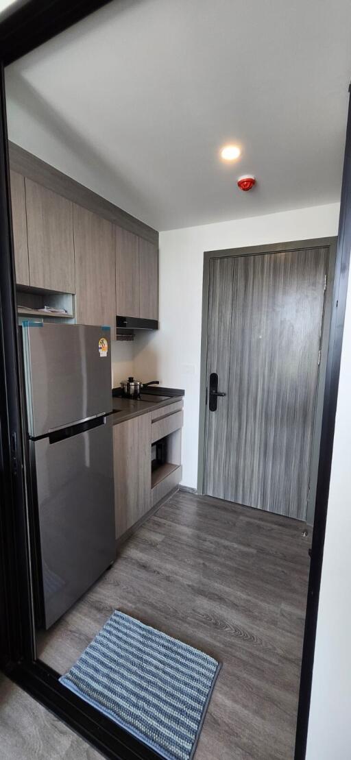 Modern kitchen with wooden cabinets and stainless steel appliances