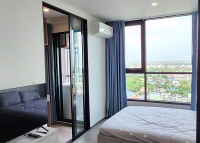 Modern bedroom with attached balcony and large windows