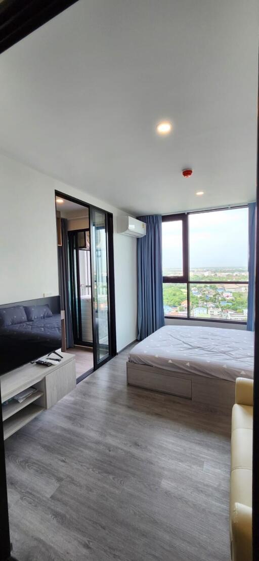 Modern bedroom with attached balcony and large windows