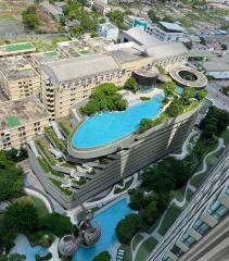 Aerial view of modern buildings with rooftop pool and greenery