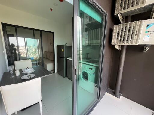 Modern kitchen with adjoining dining area and balcony view