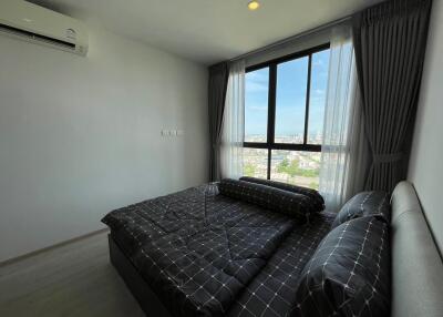 Modern bedroom with large window and city view