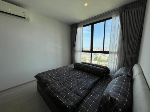 Modern bedroom with large window and city view