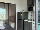 Modern kitchen and dining area with a view of another room