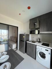 Modern kitchen with appliances and adjacent sitting area