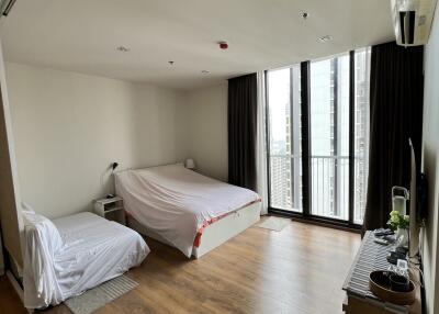 Bedroom with two beds and large window