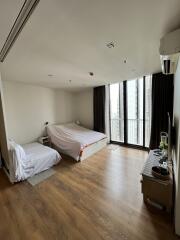 Bedroom with two beds and large window