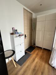 Modern entryway with storage units and wooden flooring