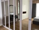 Bedroom with large mirrored wardrobe and dressing table