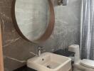 Modern bathroom with round mirror and vessel sink