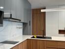 Modern kitchen with wooden cabinets and marble backsplash