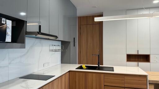 Modern kitchen with wooden cabinets and marble backsplash