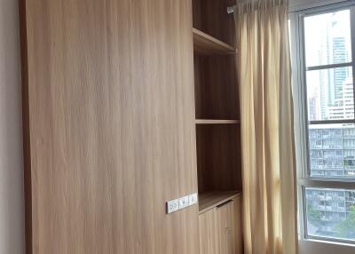 Bedroom with wooden storage unit and window view