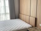 Bedroom with bed and built-in wooden wardrobe