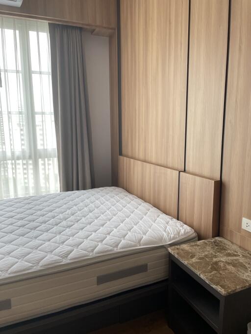 Bedroom with bed and built-in wooden wardrobe